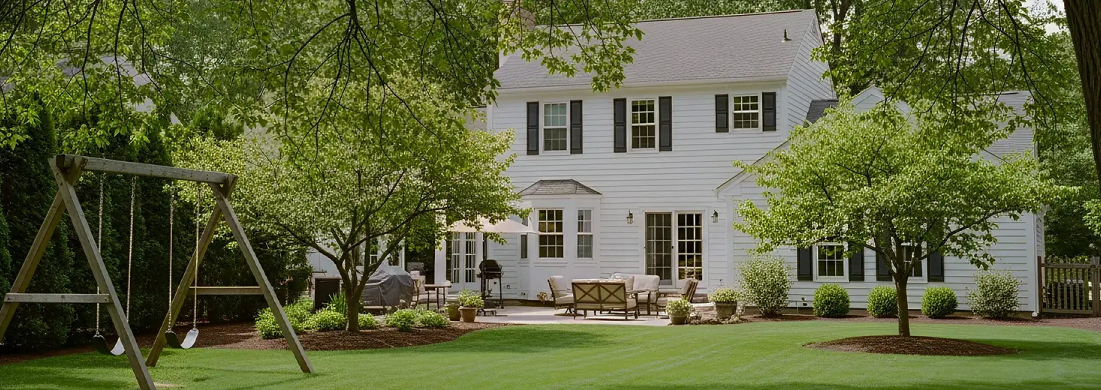 backyard with swing set and mature trees 
