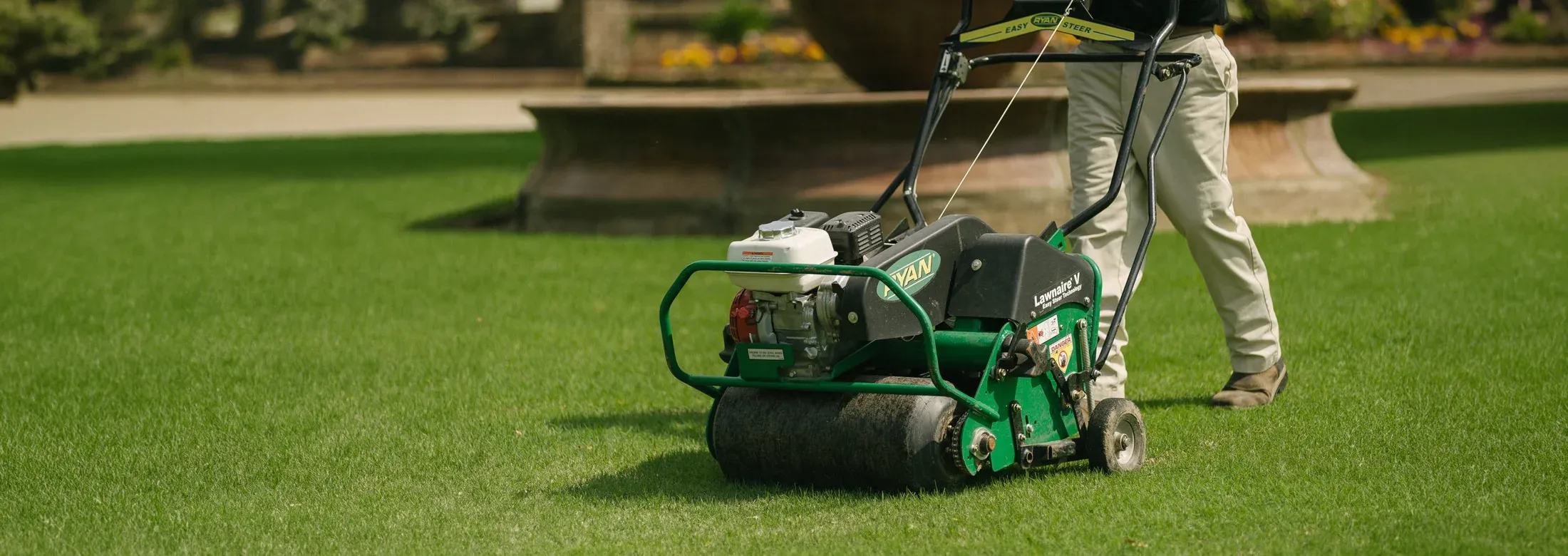 technician aerating lawn